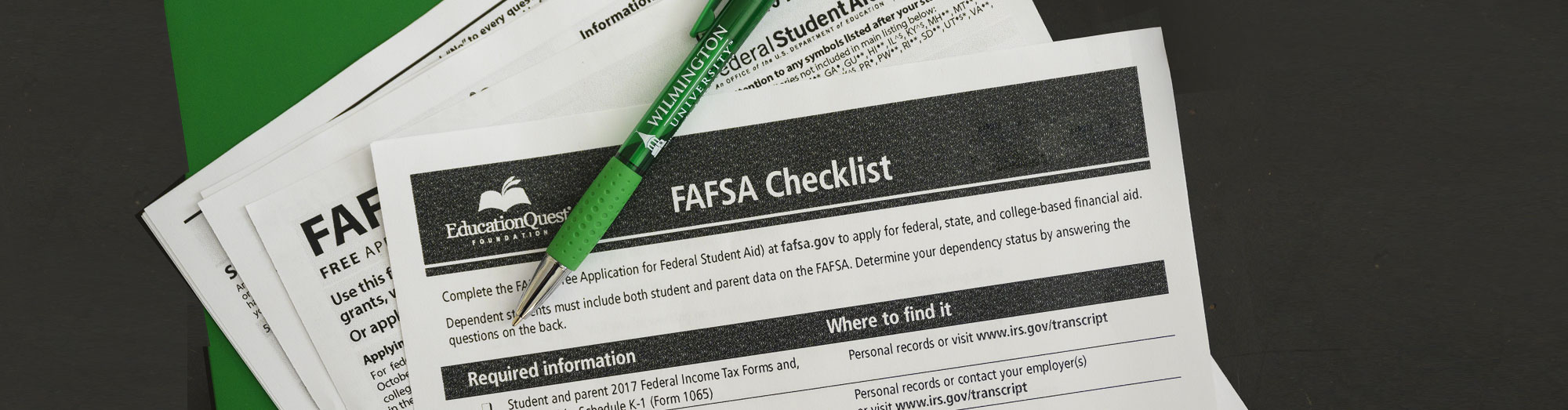 FAFSA Checklist paperwork with a green pen with wilmington university written on the pen